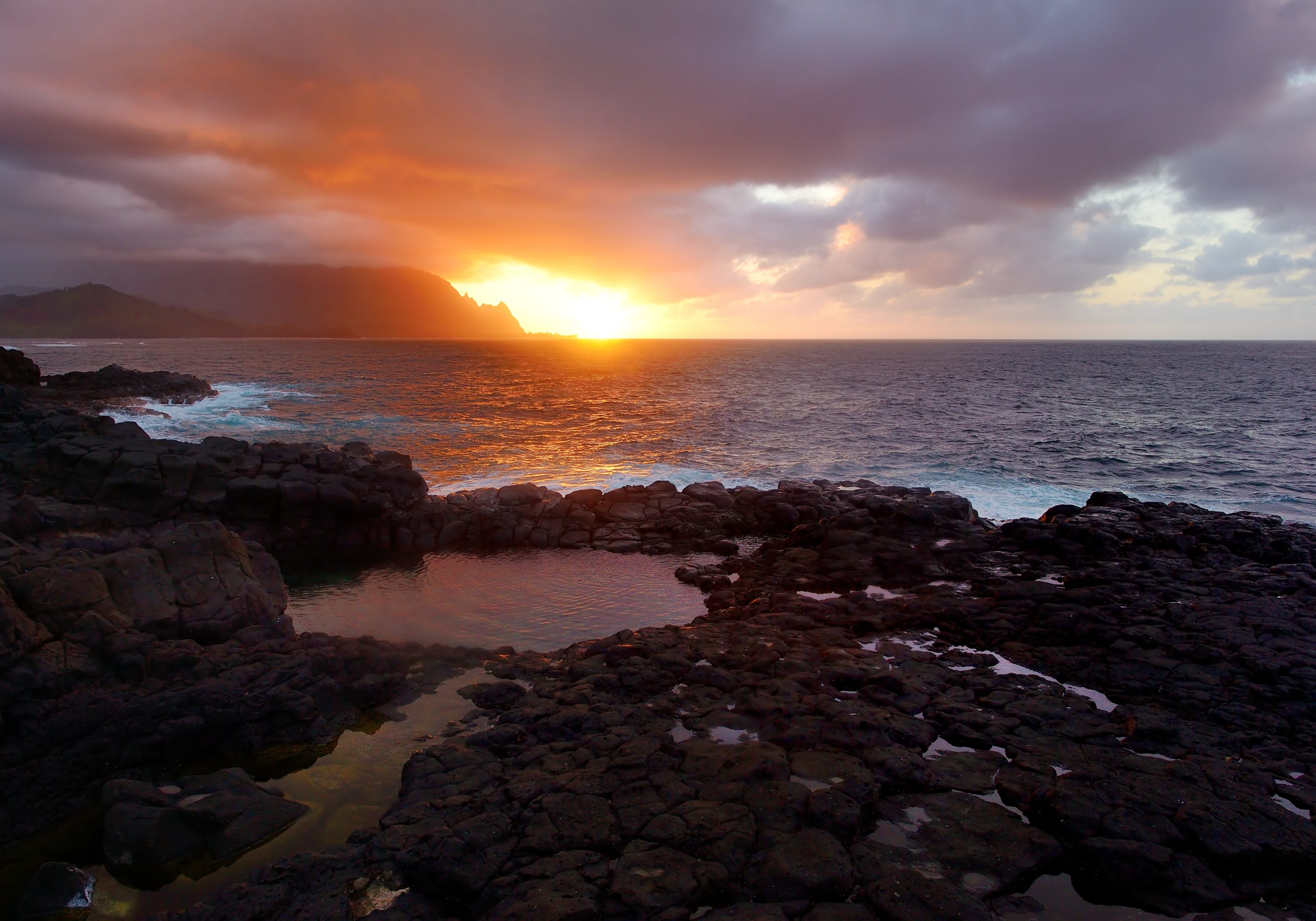 Queen's Bath on sunset on the island of Kauai, Hawaii. The pools are sinkholes surrounded by lava rock.